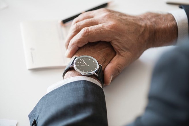 Broker checking the time while quoting small groups for health insurance.